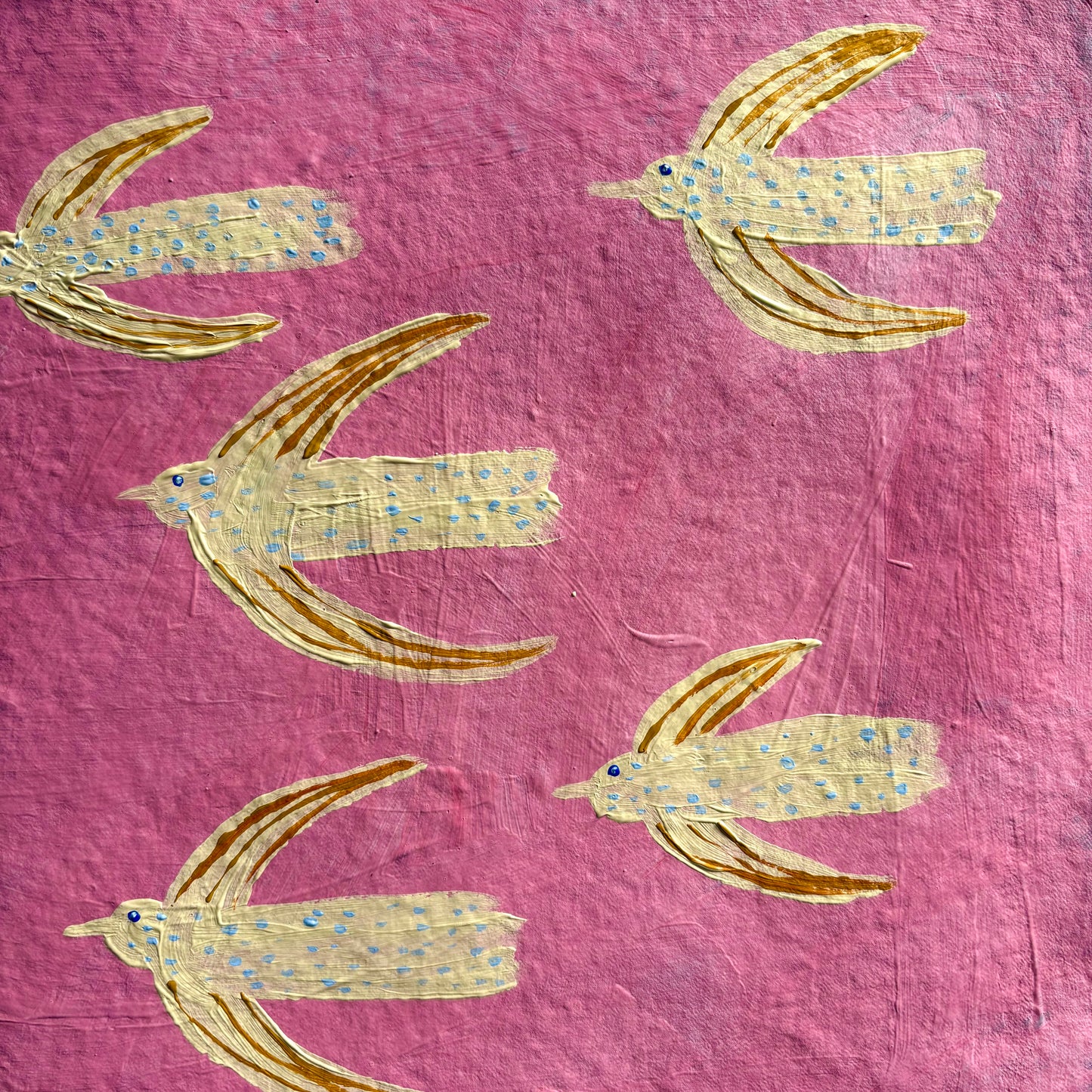 Flying in the pink sky.