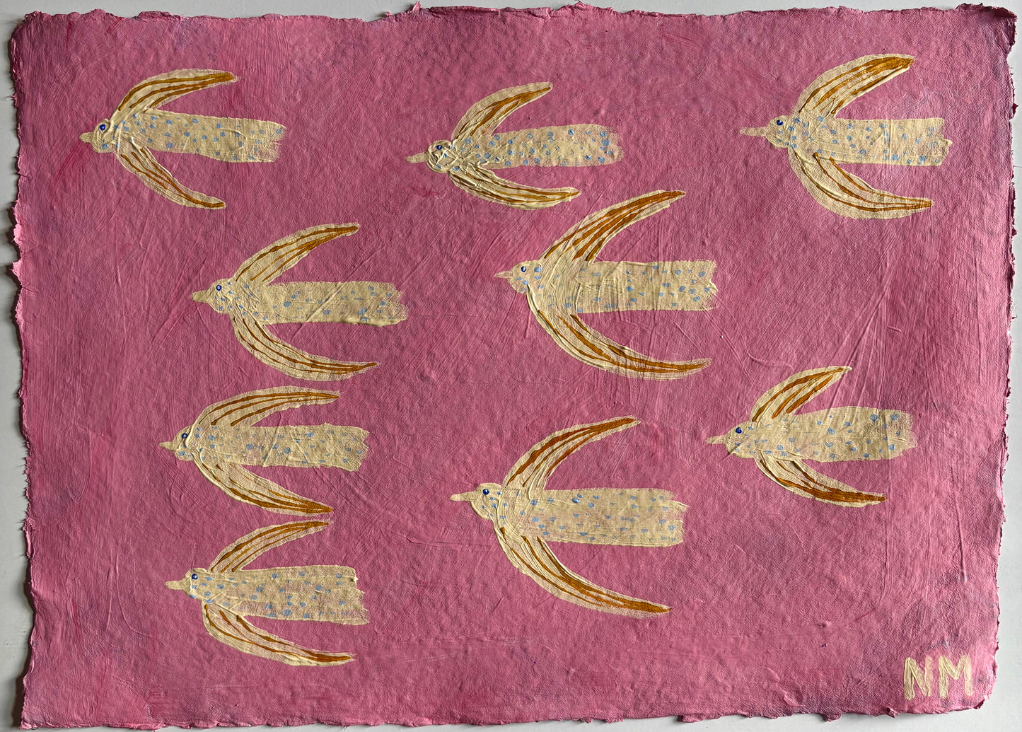 Flying in the pink sky.