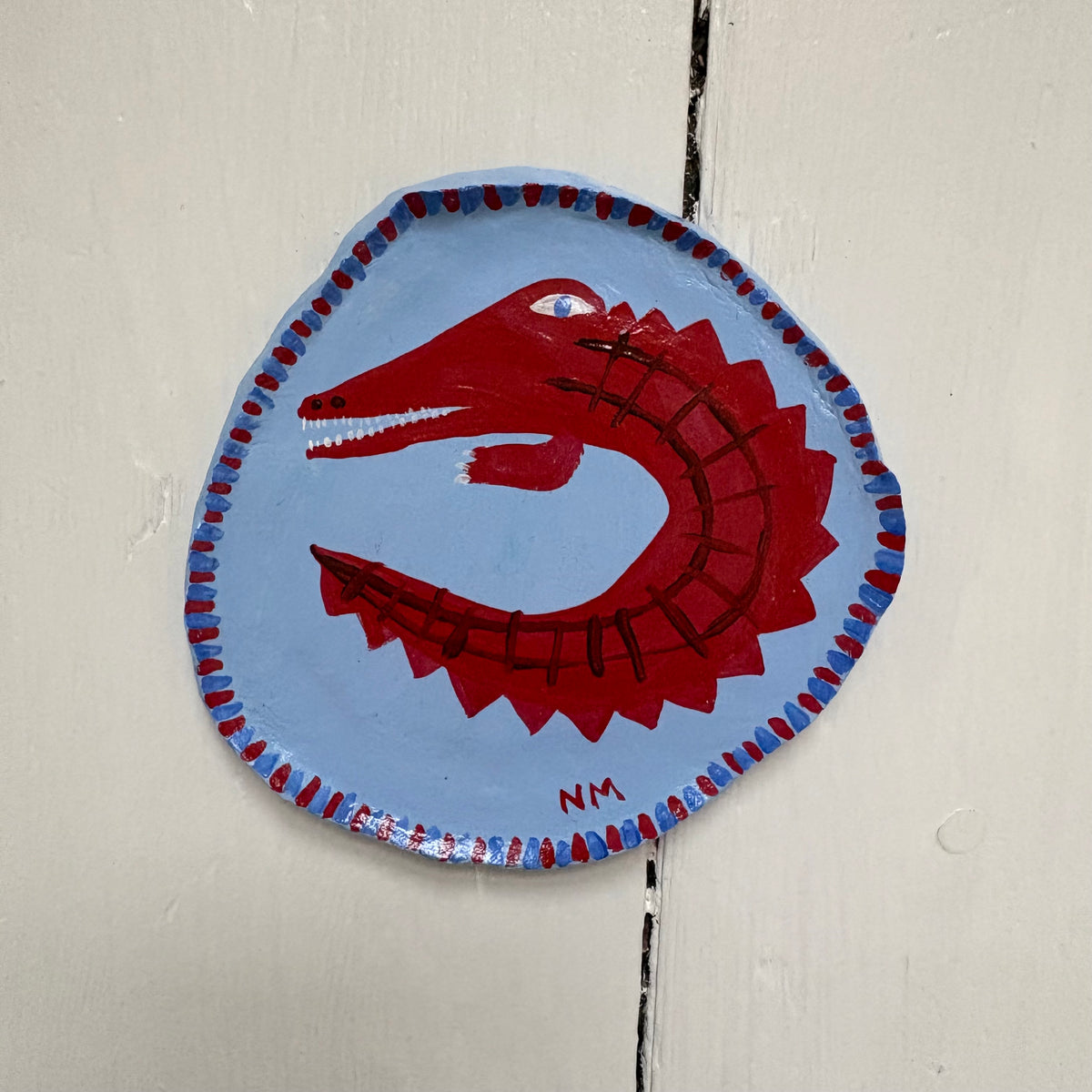 Red crocodile wall hanging.