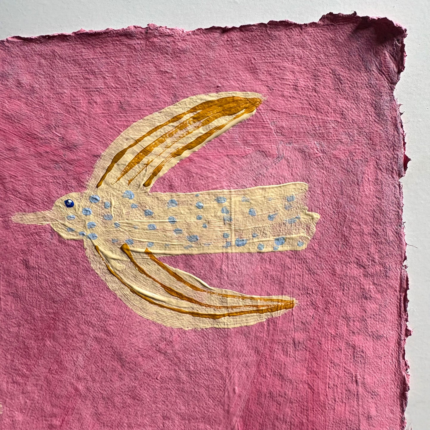 Flying in the pink sky.