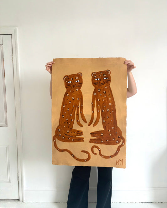 Two sitting leopards.