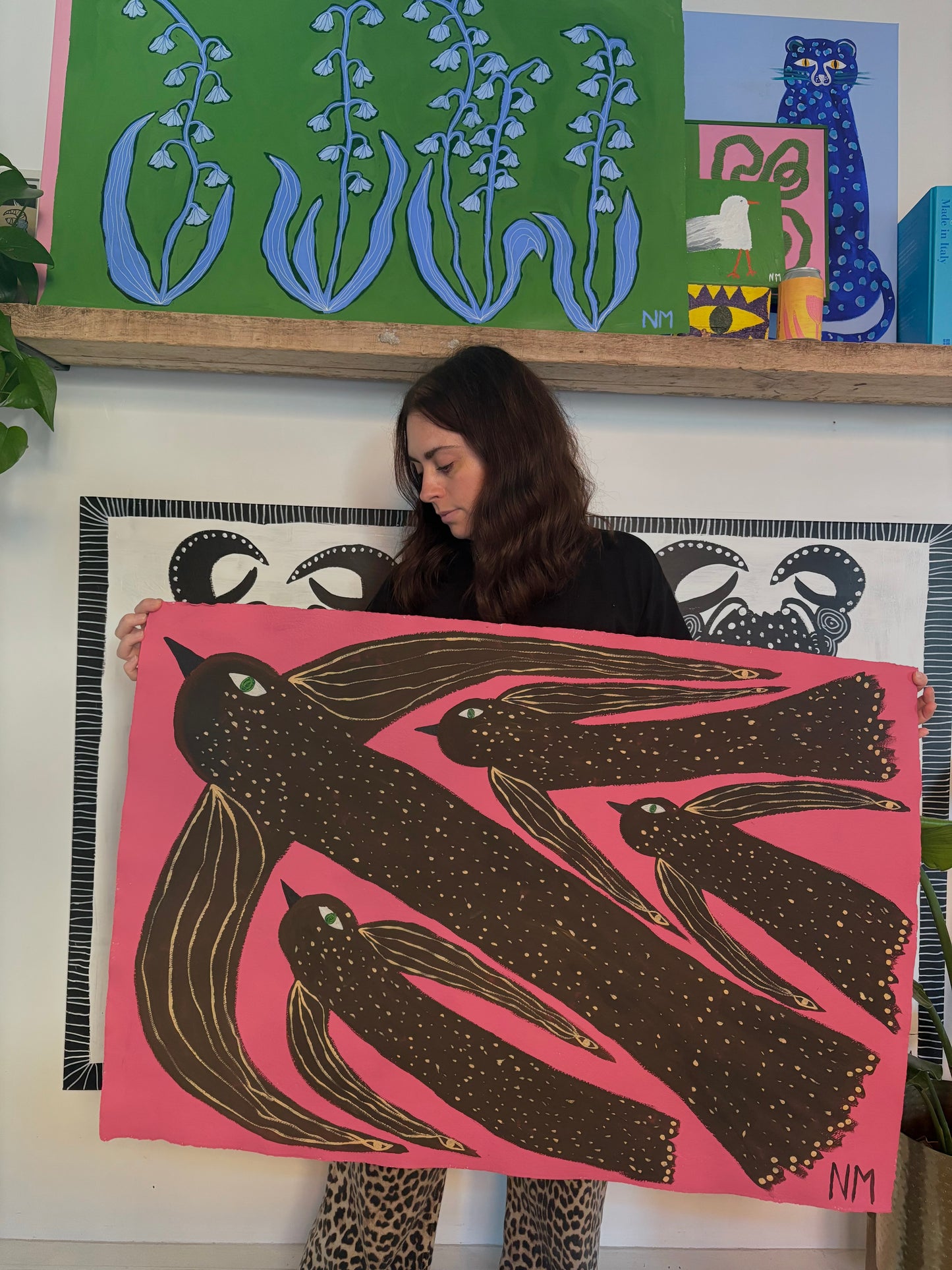 Birds flying in the pink sky.