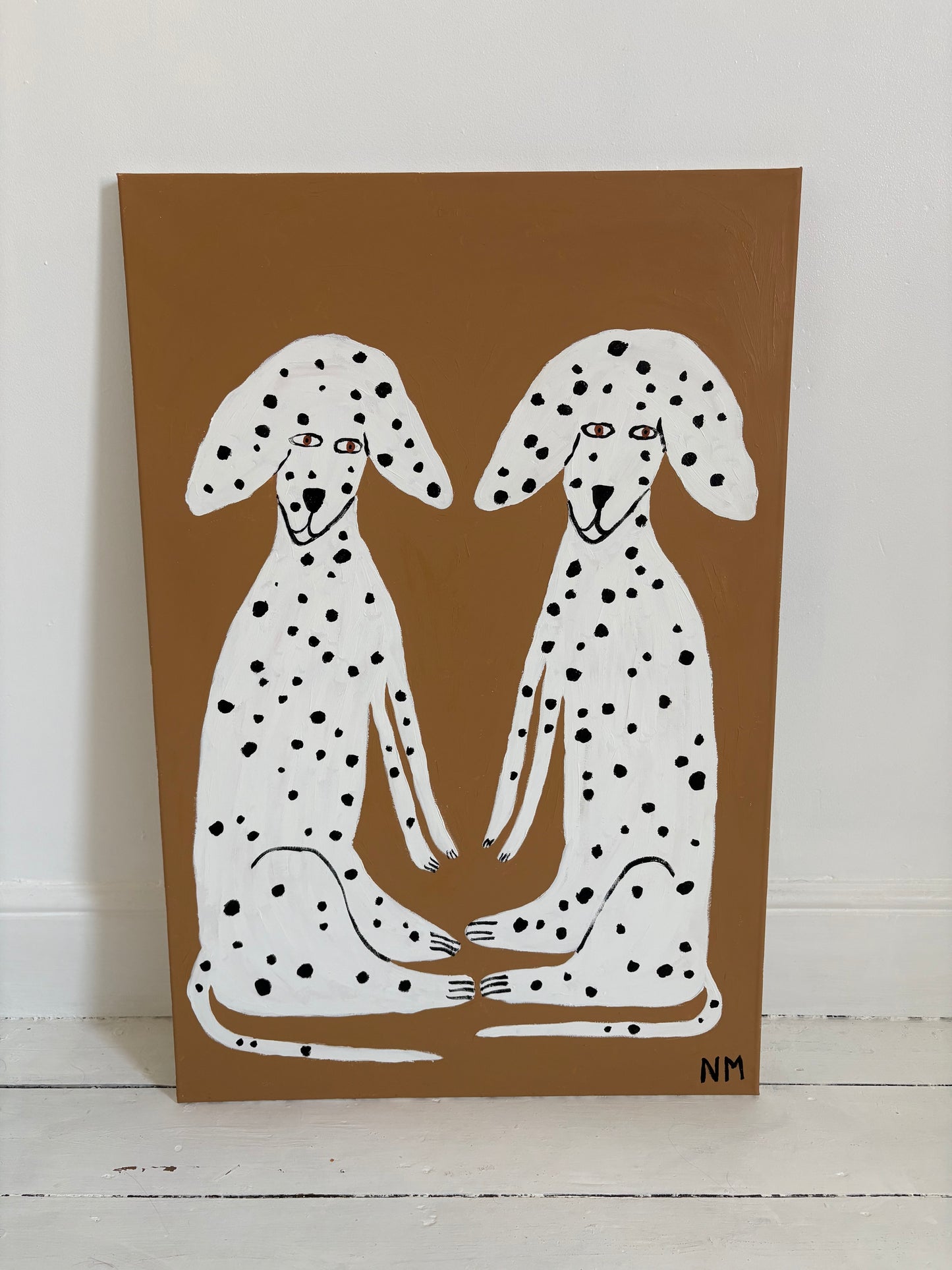Sitting Dalmatians.