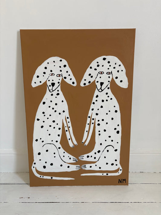 Sitting Dalmatians.