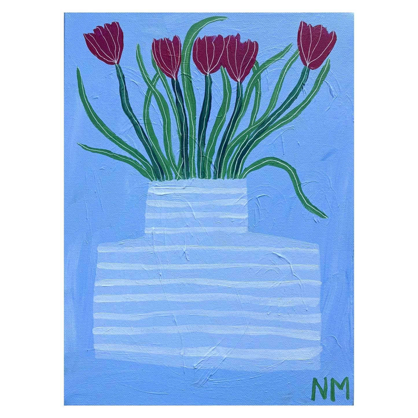 Red tulips in blue vase.
