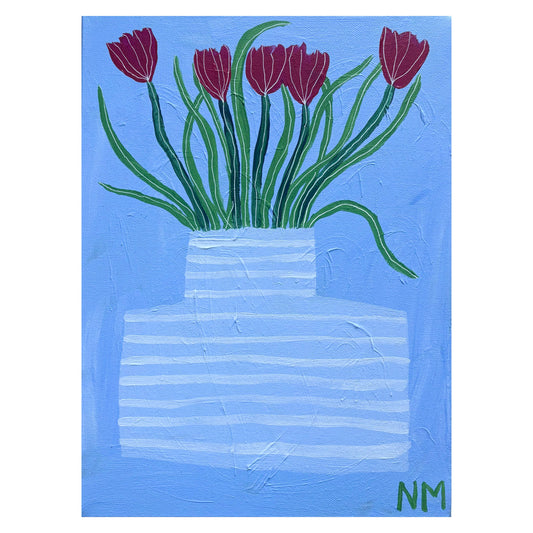 Red tulips in blue vase.