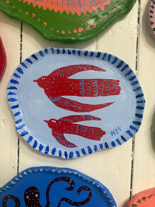 Two red birds wall plate.