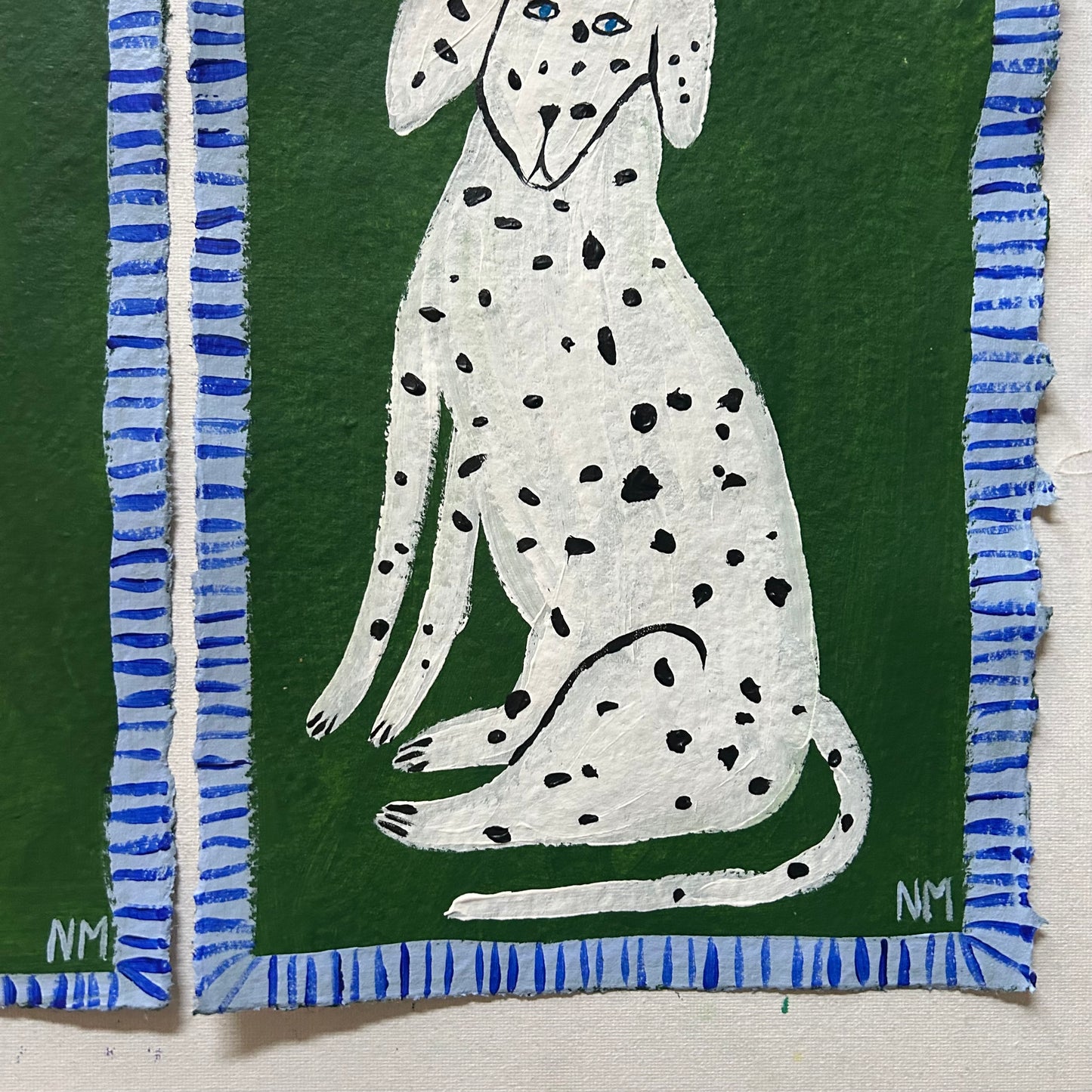 Two Dalmatians on green